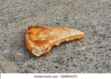 pizza-slice-dropped-on-ground-260nw-1048941071.jpg