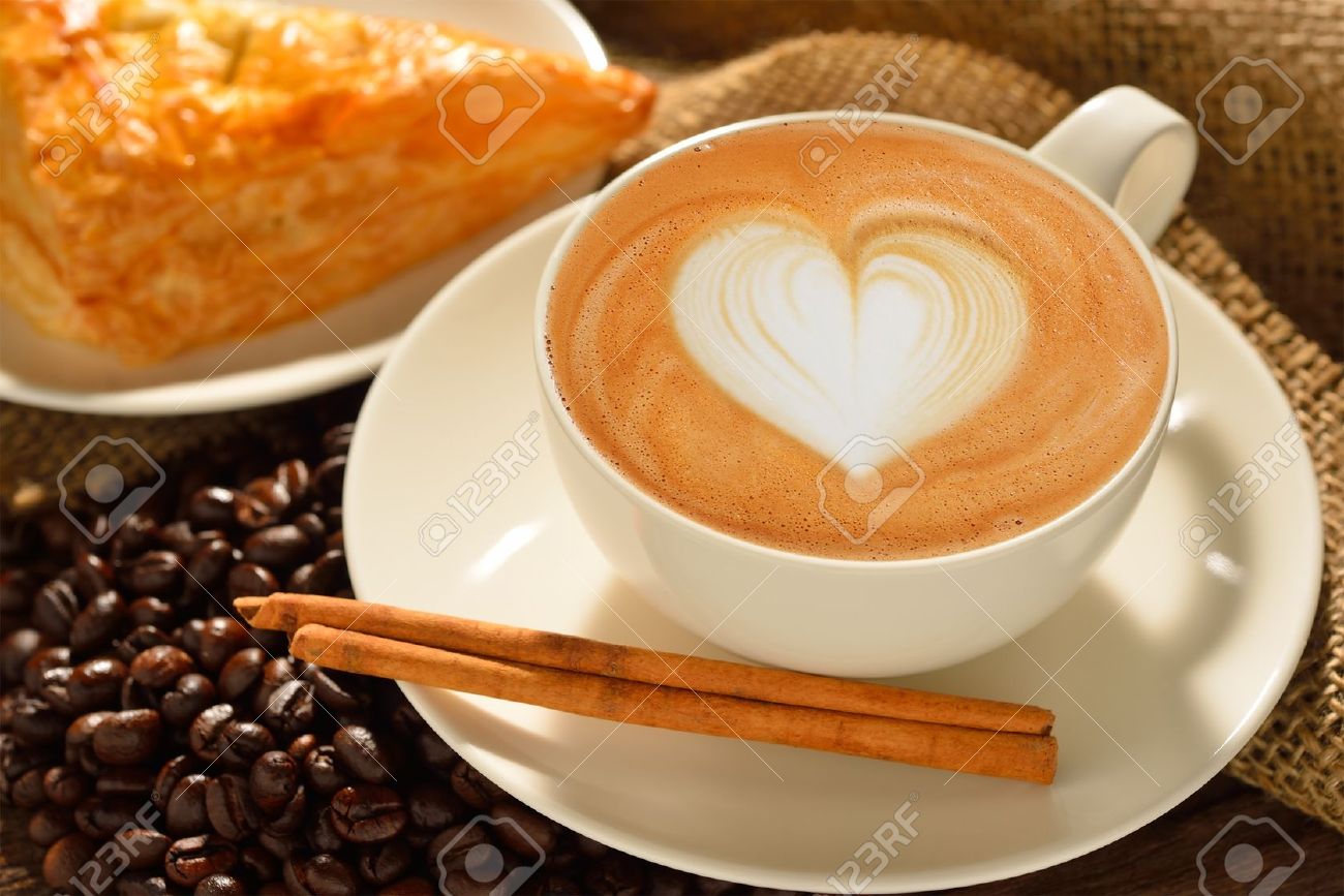 21131364-A-cup-of-cafe-latte-with-coffee-beans-and-puff-pastry-Stock-Photo.jpg