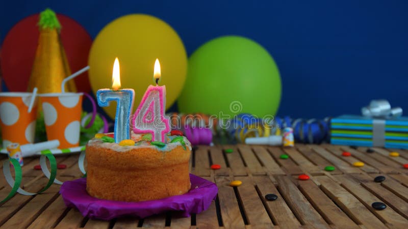 birthday-cake-candles-rustic-wooden-table-background-colorful-balloons-gifts-plastic-cups-candies-blue-136374108.jpg
