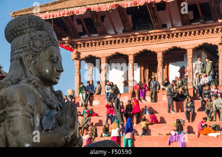 local-people-resting-on-temple-steps-at-durbar-square-statue-of-garuda-f50590.jpg