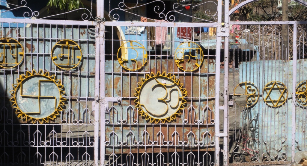 3-symbols-om-star-of-david-and-swastika-on-entrance-gate.jpg