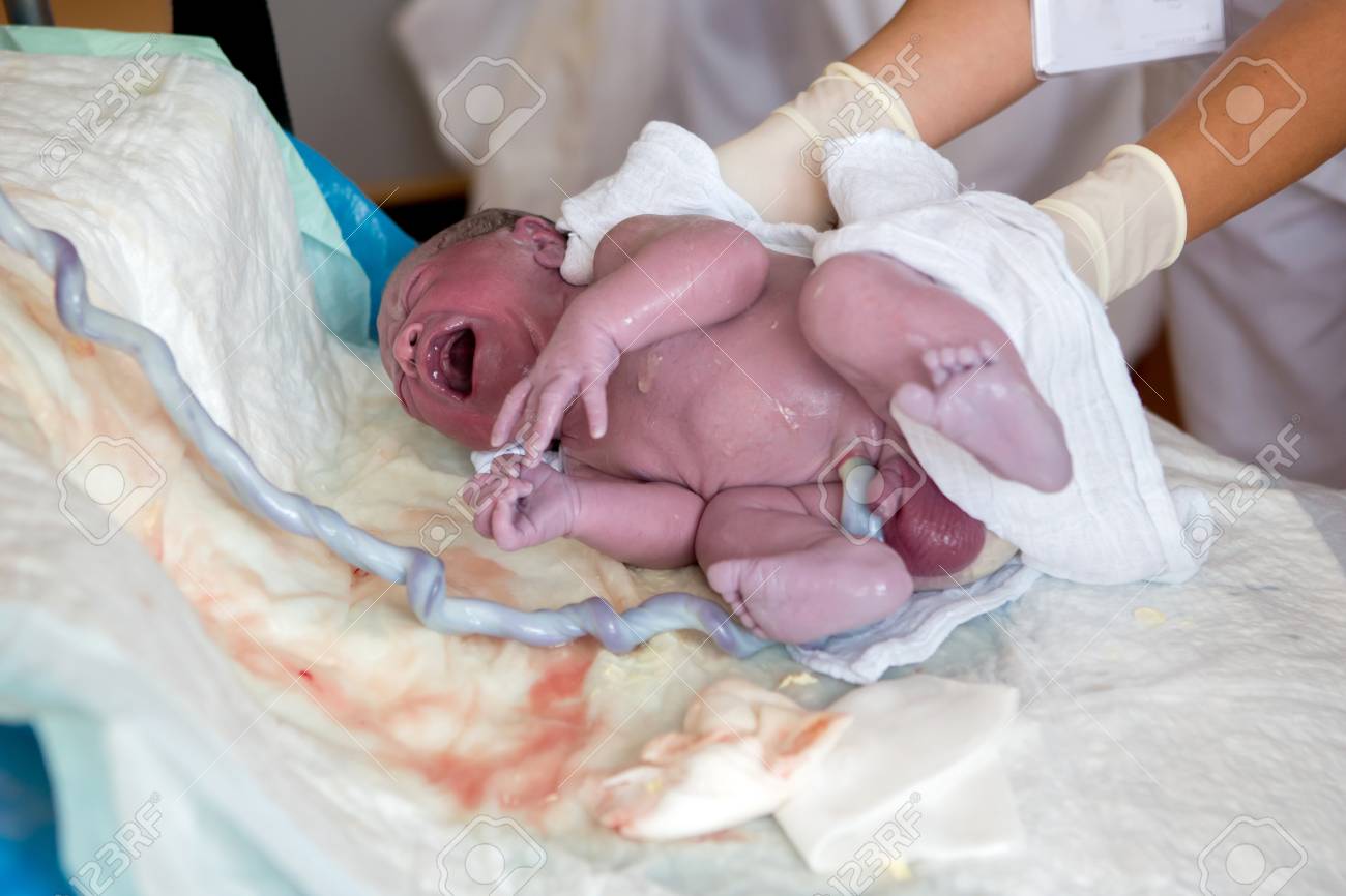 85539297-newborn-baby-boy-first-seconds-after-birth-still-attached-to-the-umbilical-cord-stump-happiness-fami.jpg